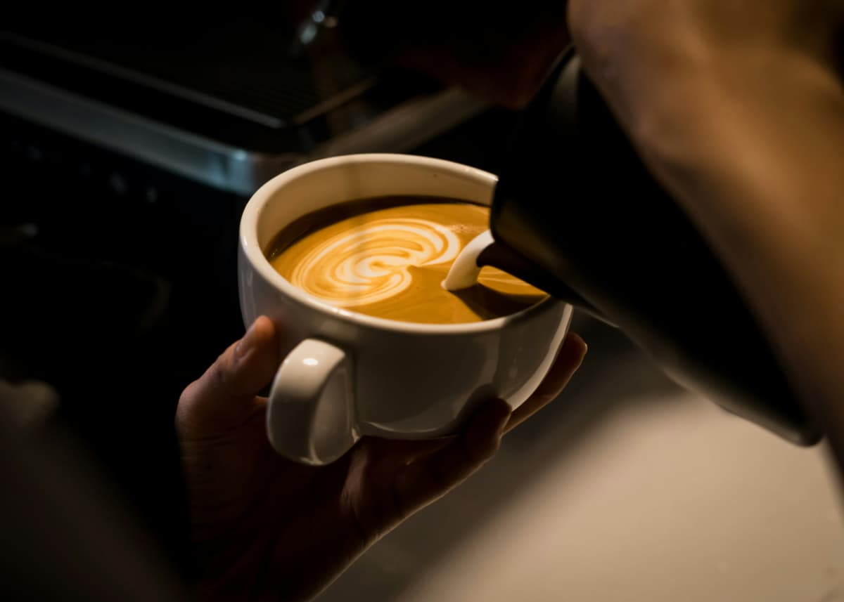 Someone pouring a delicious cup of coffee