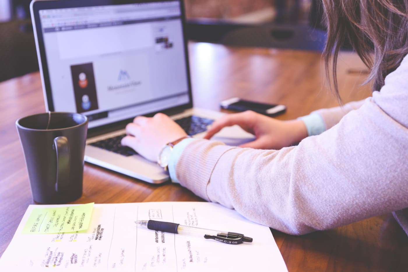 Woman working on a creative project on a laptop computer. 